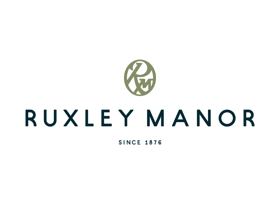 Ruxley Manor logo with a circular design element on a white background