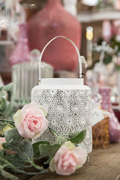 Image of a white lantern with artificial roses