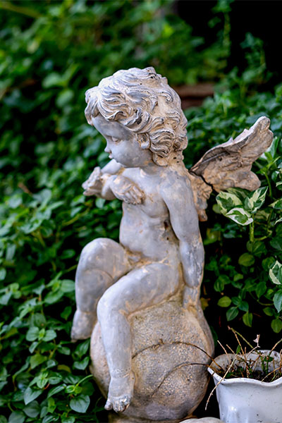A picture of a Cherub stone statue for your garden.